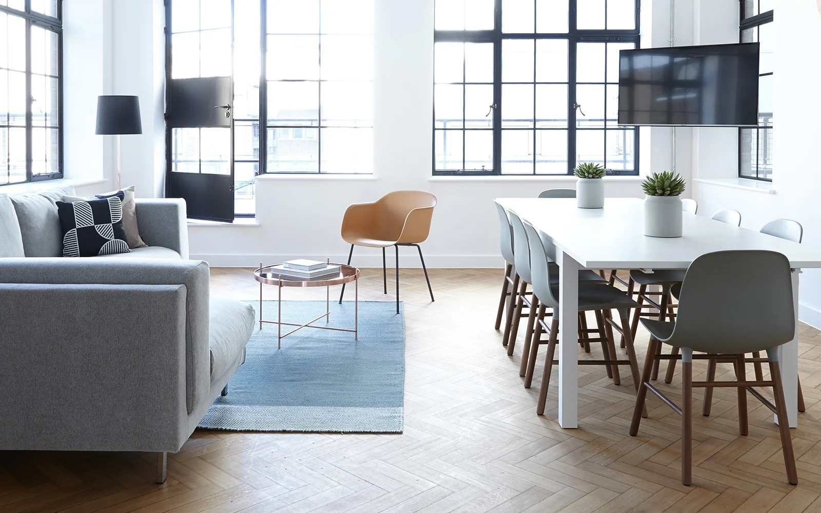Bright open-plan living and dining space with large industrial windows